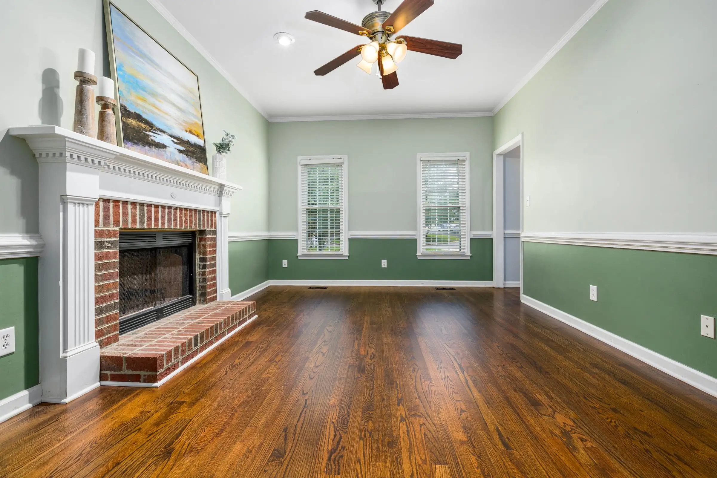 Bright living room with sage green walls and white trim
