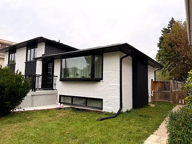 The same wing painted white with black trim around the picture window