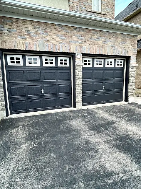 Double garage with doors painted black against brick