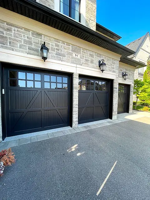 Triple garage with carriage doors refinished in black