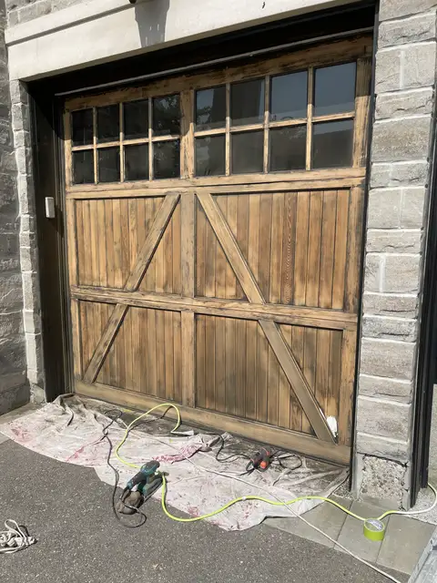 Faded, weathered wood carriage-style garage door
