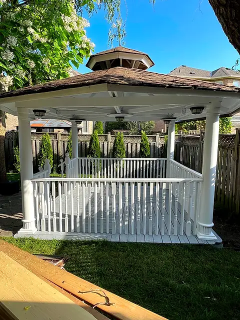 The gazebo repainted bright white on a sunny day