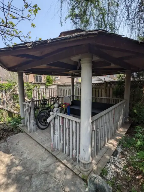 Weathered gazebo with grimy railings and posts
