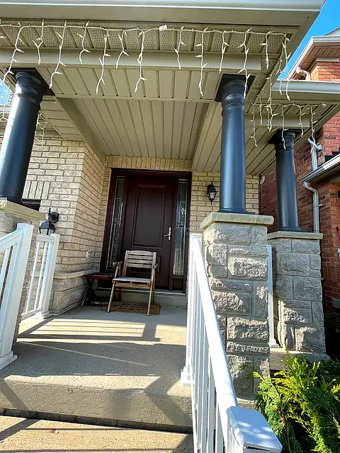 The same porch with freshly painted glossy black columns