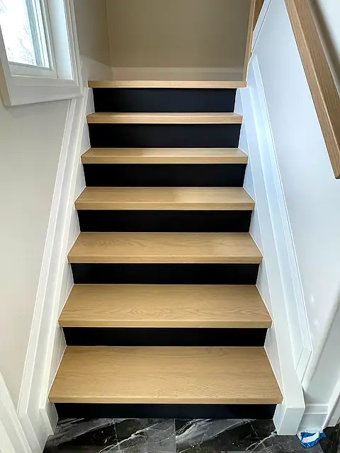 The same staircase with natural oak treads and black painted risers