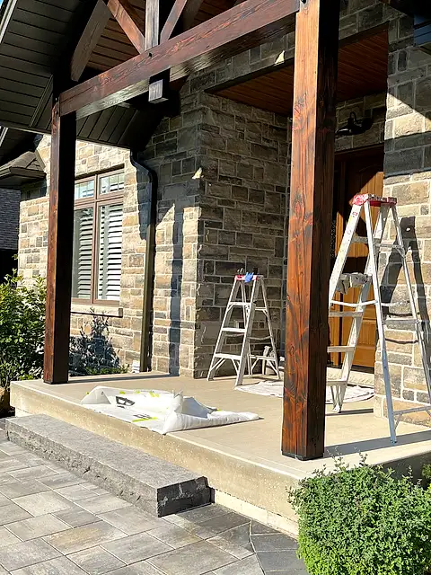 The same entrance with the timber posts and beams restained dark brown